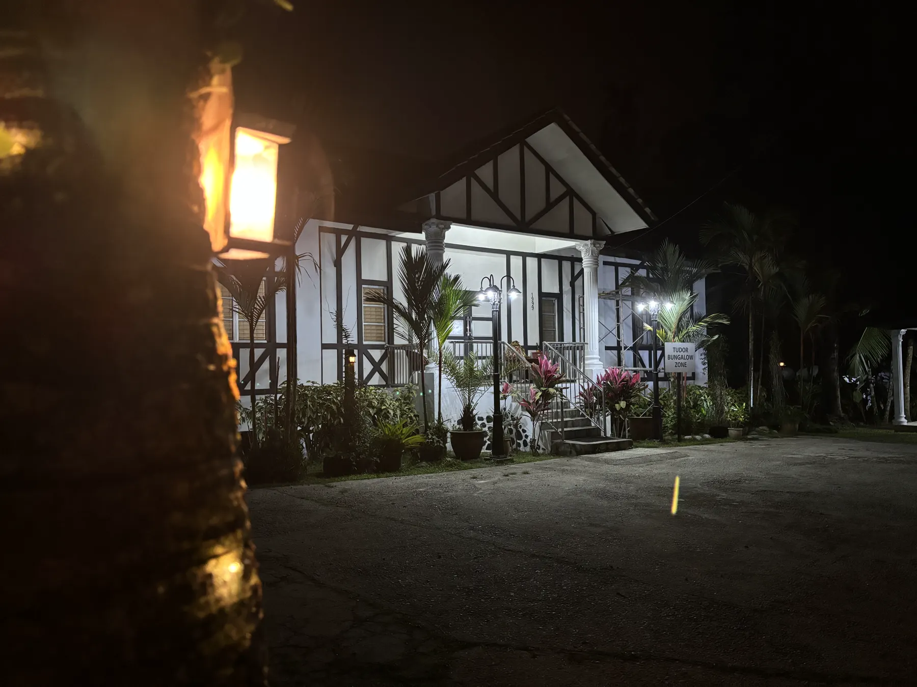 The Tudor Bungalow lit up at night