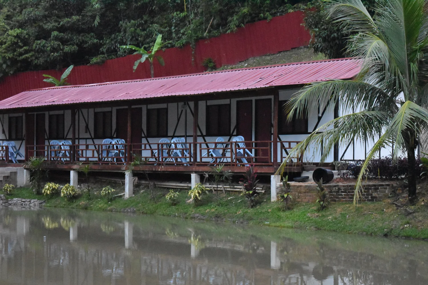 Tudor Pond Zone rooms with red roofs beside the fishing pond